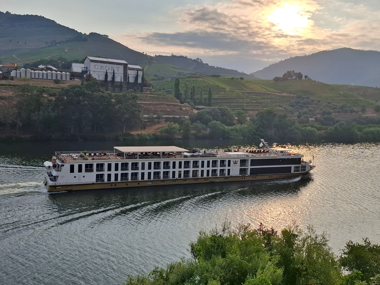 River cruise ship on the Douro at sunset, the kind of sailing river cruise discounts apply to